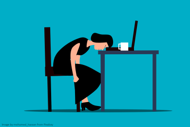 Cartoon of a woman with her head on the desk with a laptop and mug, looking bored.