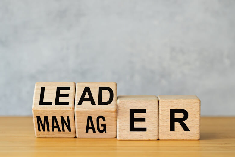manager-vs-leader-symbol-businessman-arranged-wooden-cubes-on-the-table-to-form-the-words-manager-to-leader-business-concept