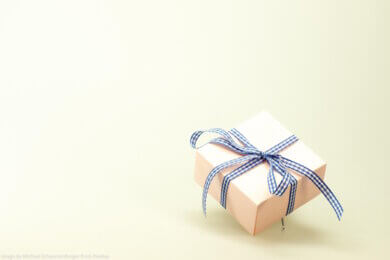 small gift box with blue and white ribbon